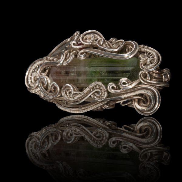Hand crafted silver pendant with a green gem